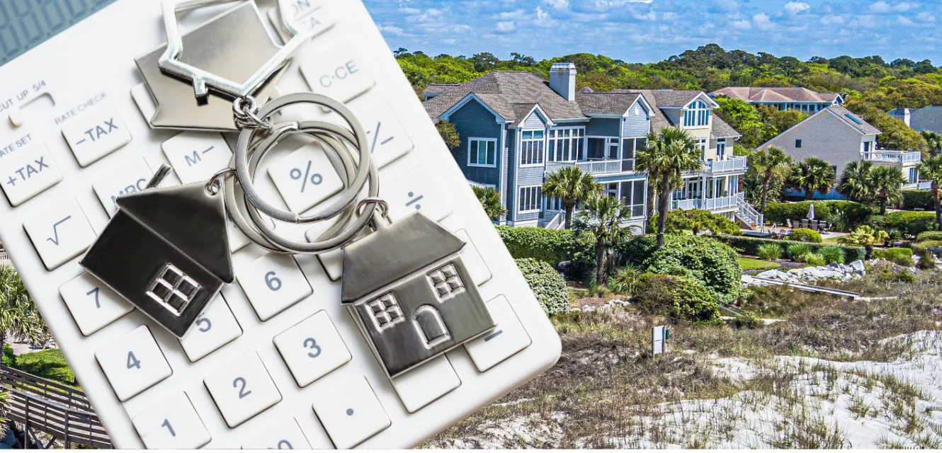 small house on keychain laying beside calculator
